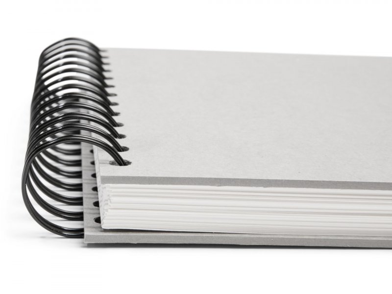 Wire bound or spiral bound sketchbook made from grey board isolated on  white background. Stock Photo by ©Tirachard 96213064